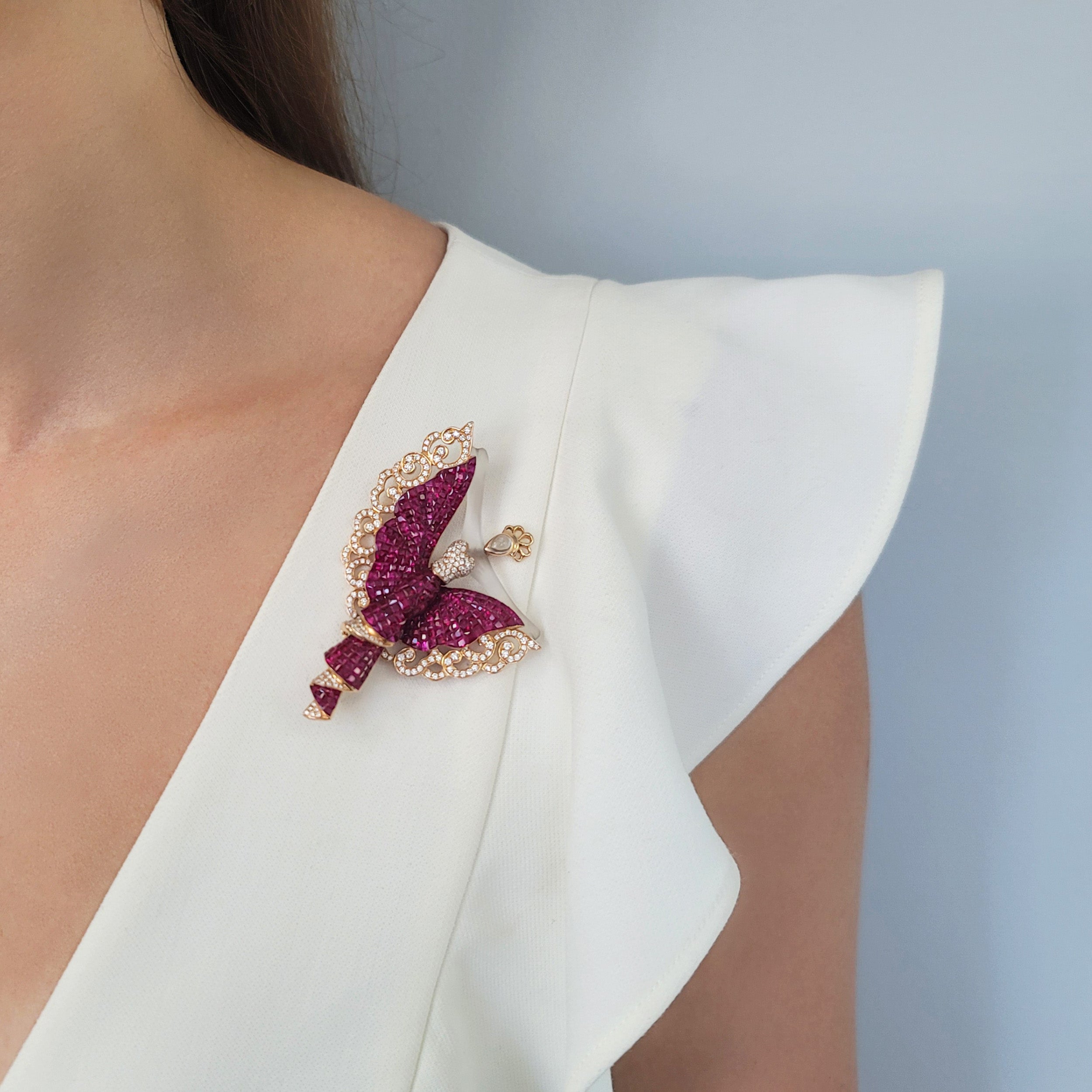 Invisibly set ruby, diamond and crystal brooch in 18k yellow gold.