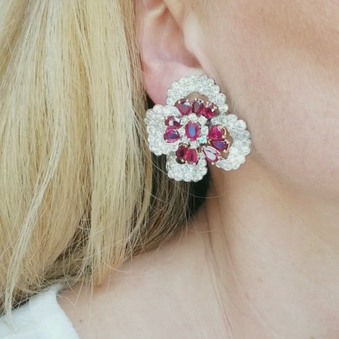 Stunning ruby and diamond earrings by Oscar Heyman, crafted in platinum and 18k yellow gold, designed as large flower blossoms encrusted with 144 round brilliant cut diamonds and accented with 22 oval shaped rubies, secured with omega fastening. Diamonds total weight approx. 16.5ct. Color range from E fo F Clarity range VS+ Rubies total weight approx. 7.5ct. Measurements 36mm by 37mm Weight 49g. Stamped Plat, 18k and numbered Ref# 810-000-1987