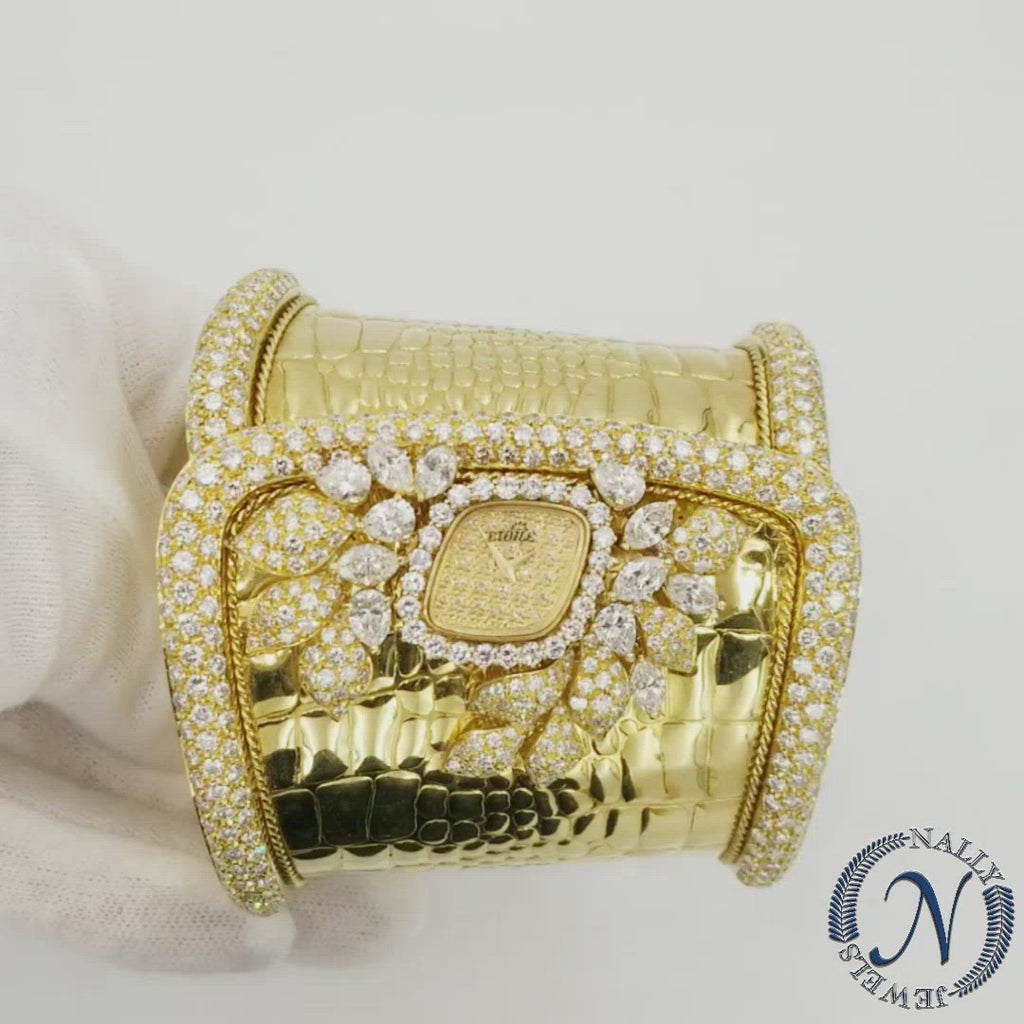 Diamond watch crafted in 18k yellow gold, design as rounded edges cuff with a crocodile scales pattern and beautifully detailed rope motif made out of 18k yellow gold, and accented with pave set round diamonds and adorn with pear and marques shape diamonds, arranged in a elegant floral motive.  Circa 1970  Diamonds total weight approx. 20ct. Near colorless, clarity Vs.  Size 6.5". Height 2.75". Weight: 153.1 grams