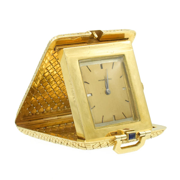 Vintage Pocket Watch / Travel Clock by Van Cleef & Arpels, crafted in 18k woven yellow gold, design as a foldable compact box, adorn with a cabochon sapphire button that also is a opening mechanism and small handle.  Inscribed Van Cleef & Arpels, NY with serial number and stamped 18k  Measurements 1.5" by 1.75" by 0.375" Weight 62.9g.  Circa 1960  Ref# 950-000-2099