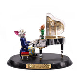 Tom and Jerry Statue, crafted in 18k gold, featuring Tom playing the piano and Jerry accompanying him on violin. The grand piano opens to reveal the 18k yellow gold strings. The entire sculpture is made with 18k white and yellow gold and collectively set with approx. 20ct. of round brilliant cut diamonds.  Tom and Jerry figures are beautifully inlaid with colorful enamel bringing the beloved characters to live.